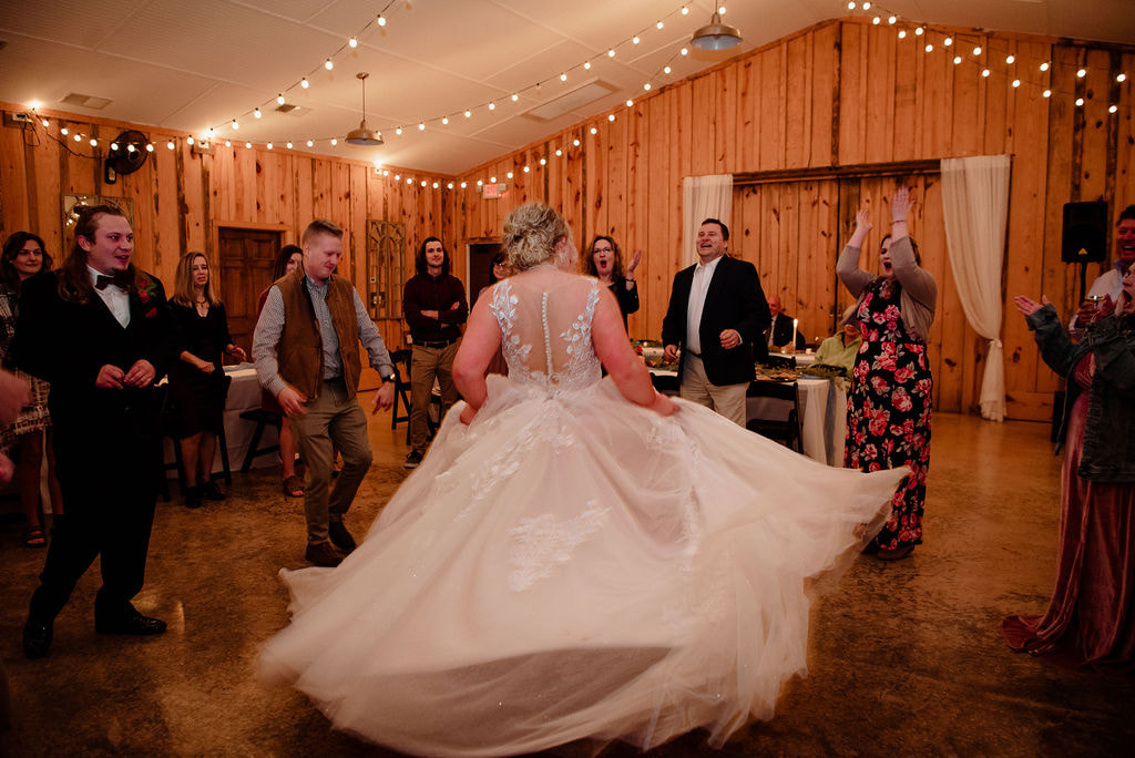 Bride twirling in wedding dress at reception at Georgia farm wedding venue
