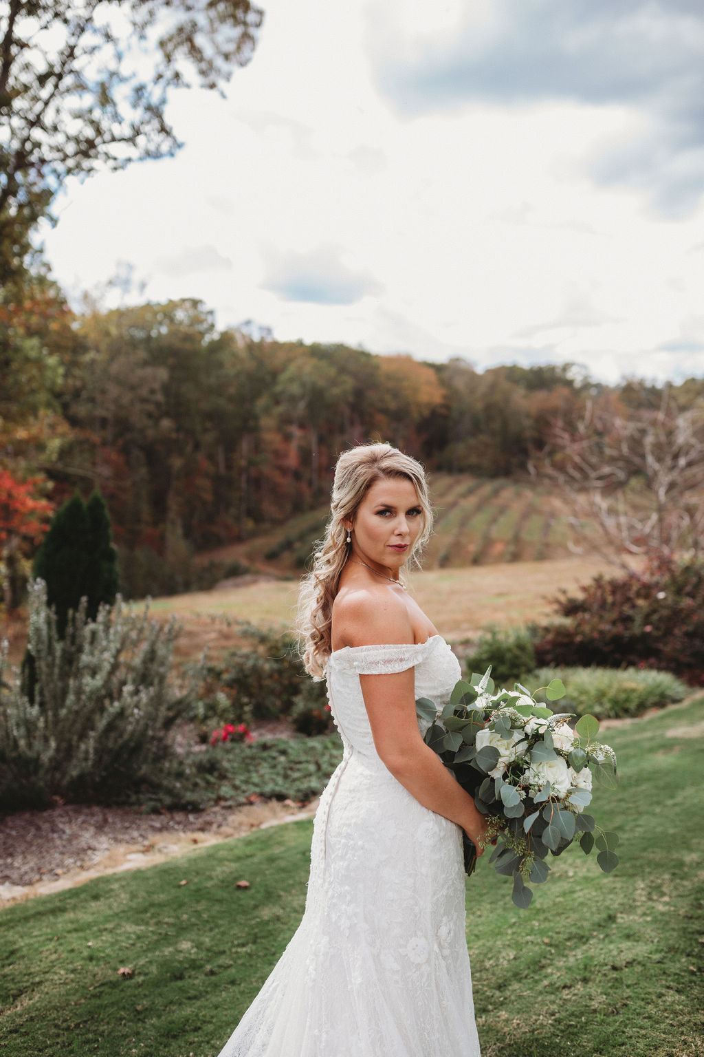 Bride on hilltop in Fall at Georgia barn venue