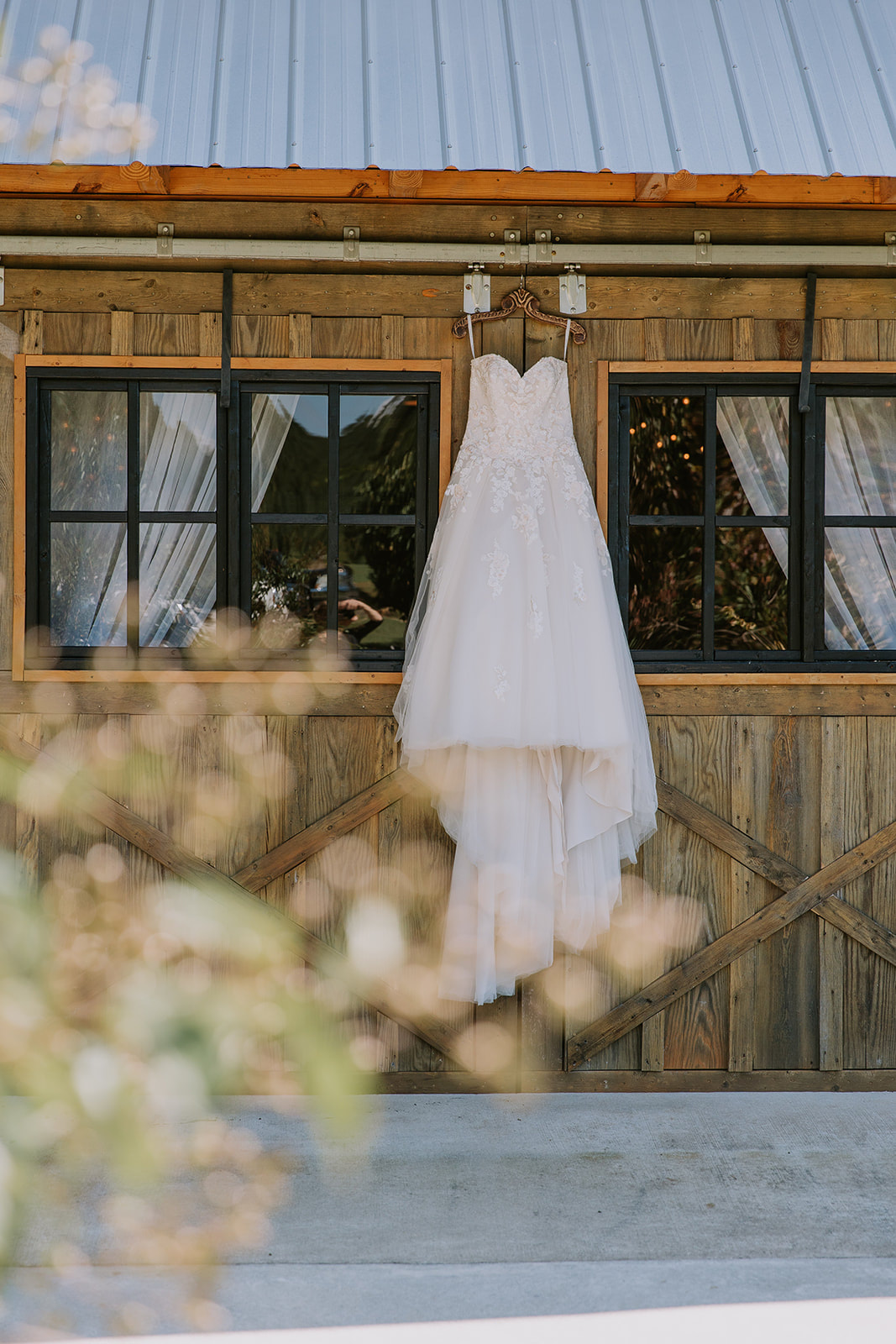 Wedding dress in front of modern barn doors at north georgia wedding venue