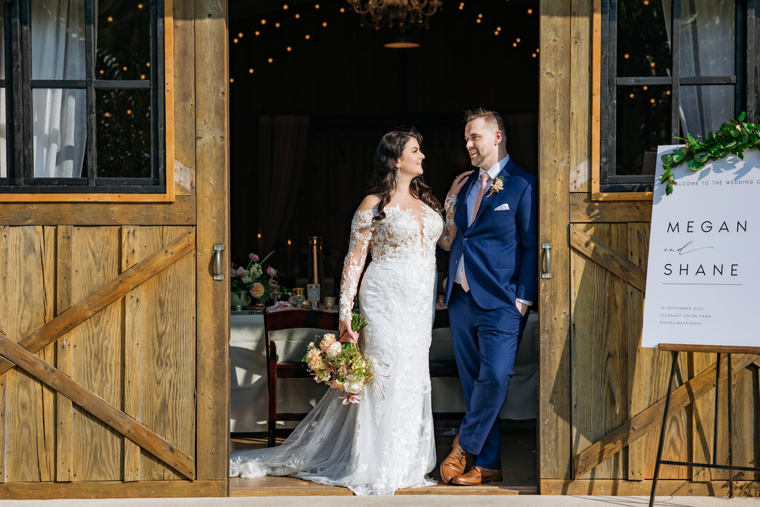 Bride and groom at barn doors in Canton, ga
