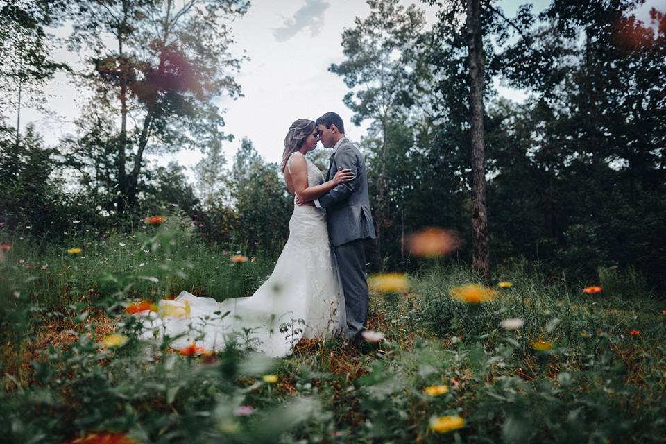 Bride and groom in wildflowers at Georgia wedding venue