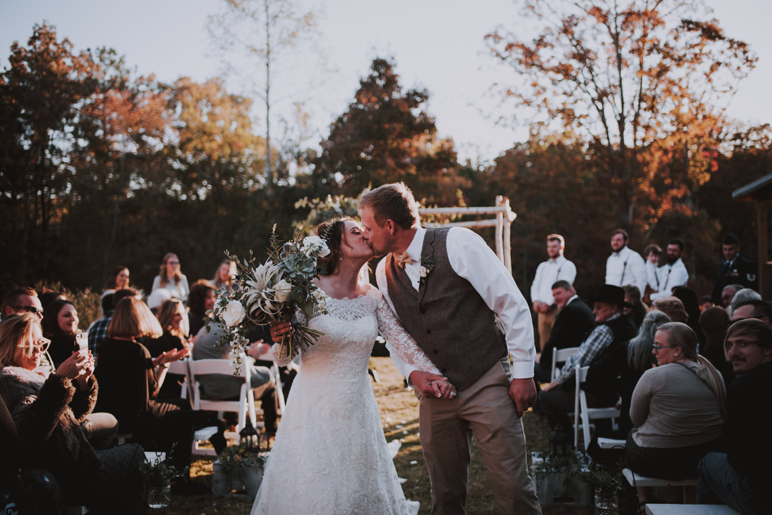 Bride and groom kiss at fall ceremony in Canton, ga