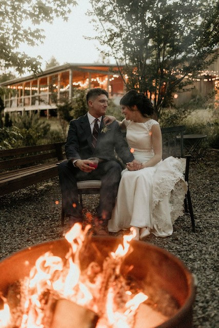 Bride and groom at fire pit at North Georgia barn