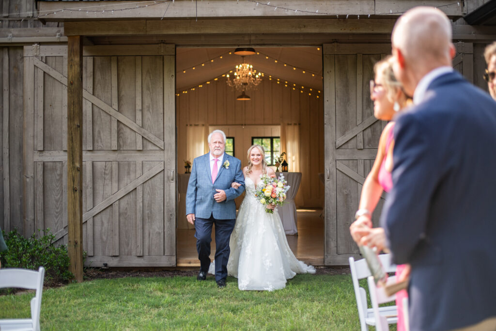 Bride and dad entering ceremony at venue for marietta ga wedding