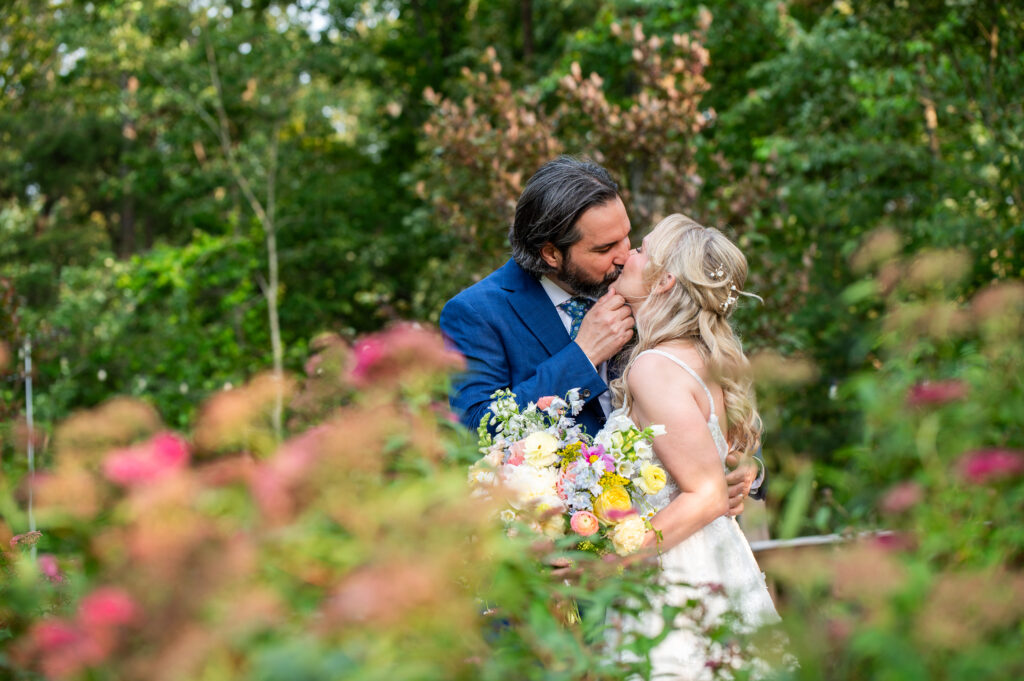 Couple kissing in garden at venue for a marietta ga wedding